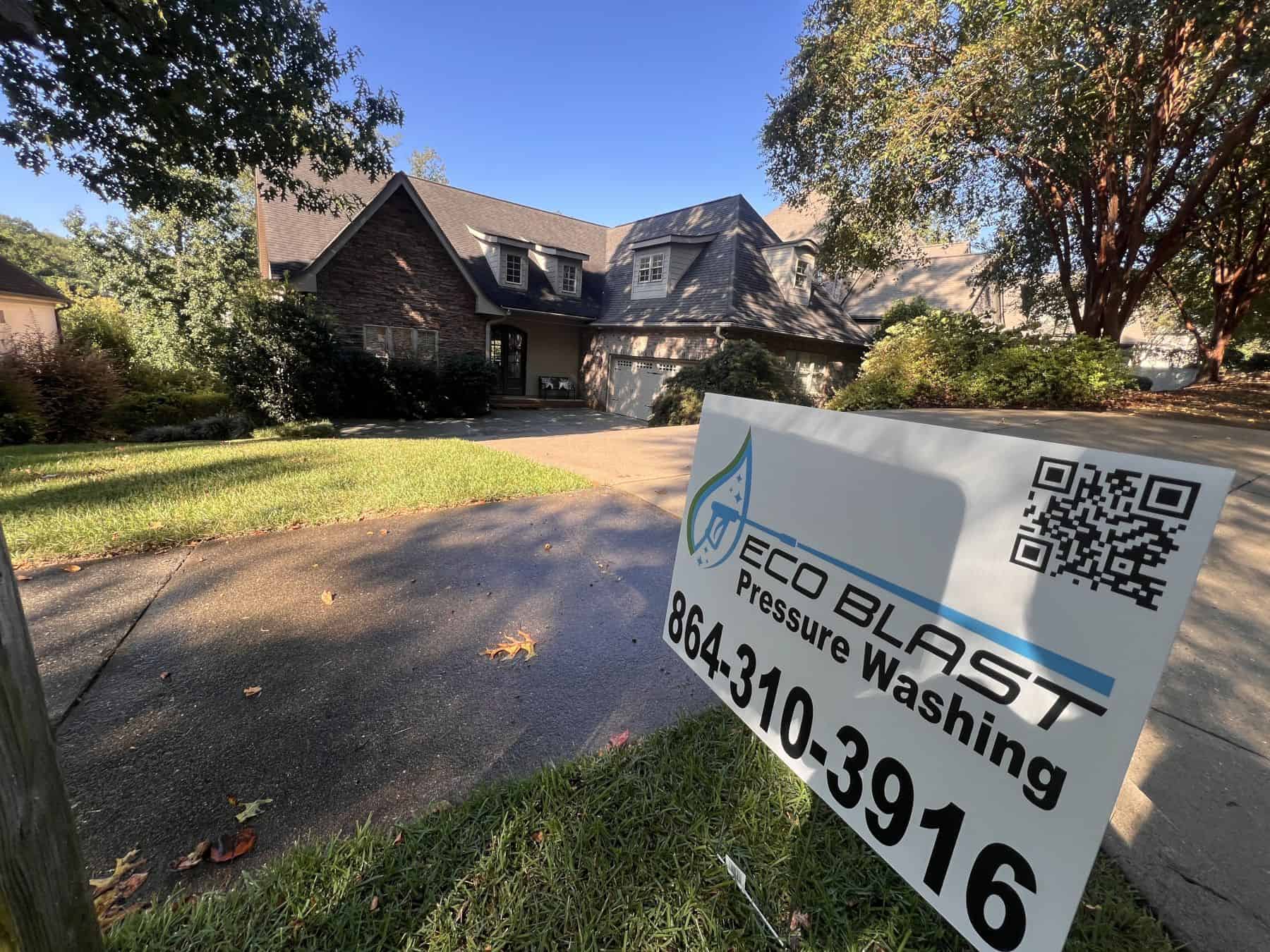 Eco Blast Pressure Washing yard sign in front of a freshly soft-washed home in Greenville SC