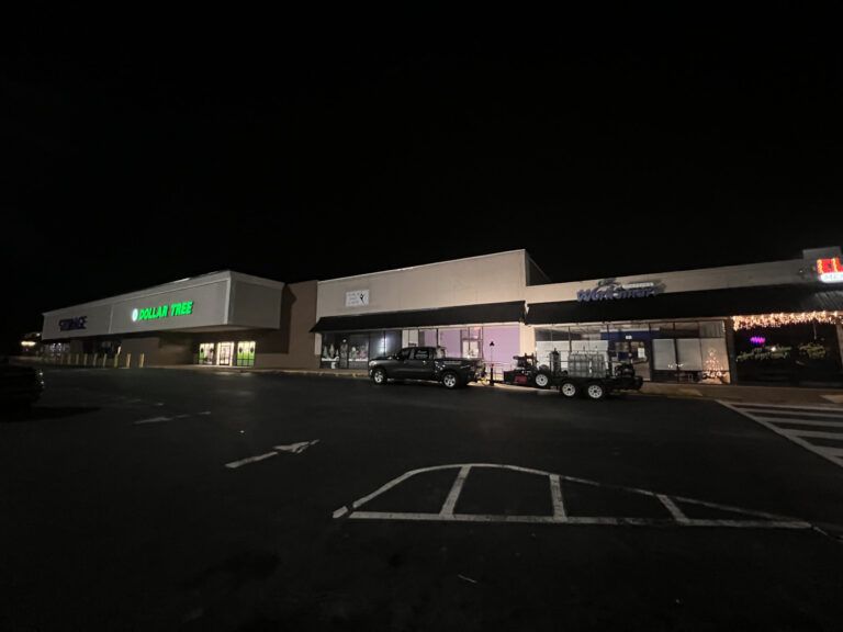 pressure washing crew at retail building