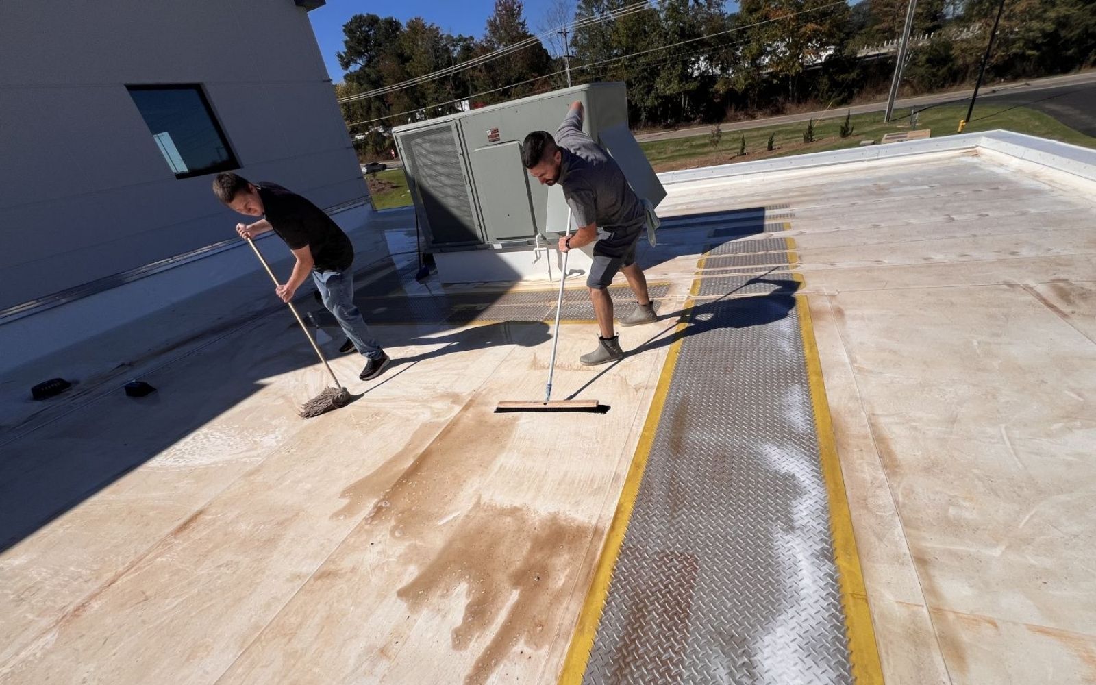 Our crew cleaning a commercial flat roof