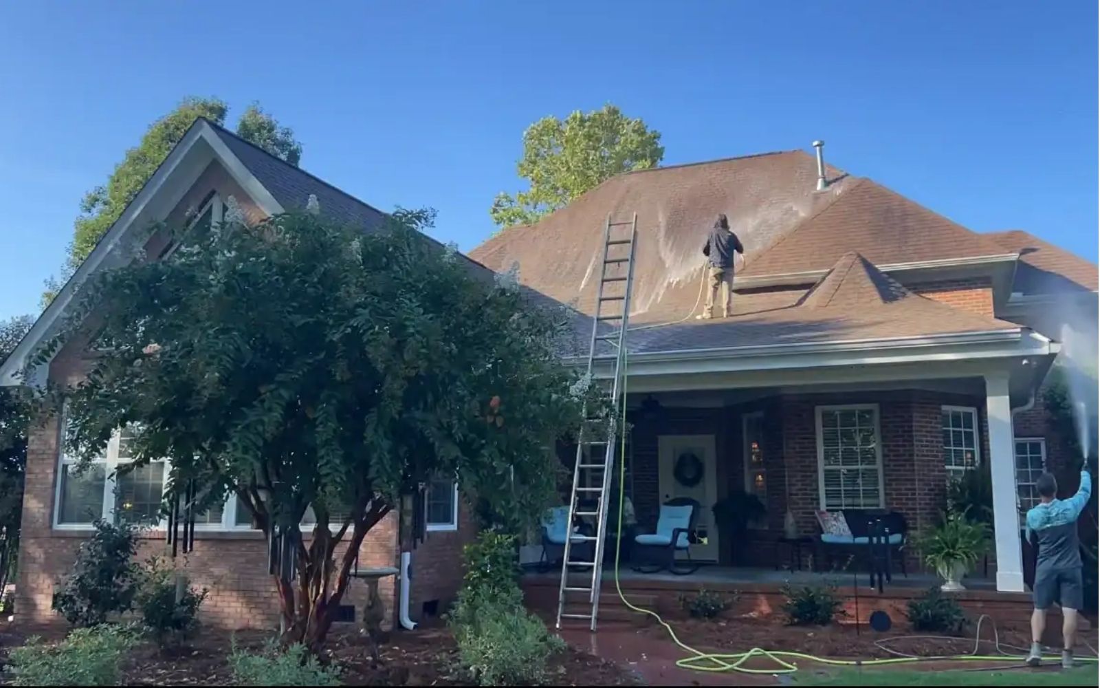 Our team restoring a roof with soft washing