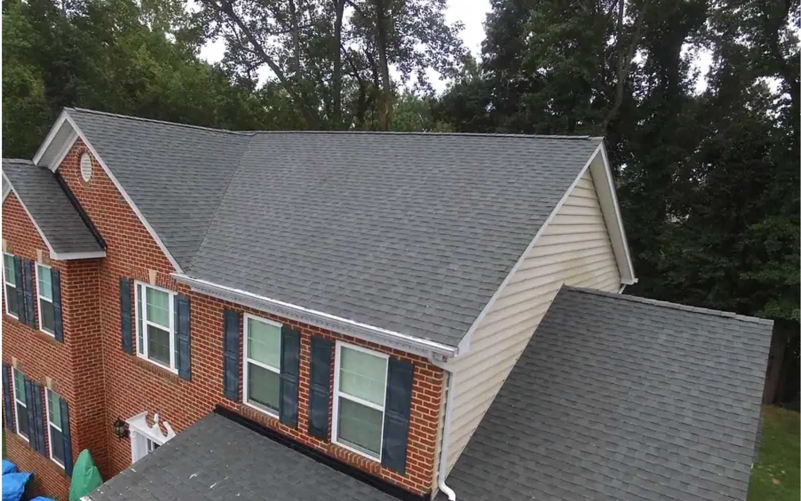 Our technician washing an asphalt shingle roof